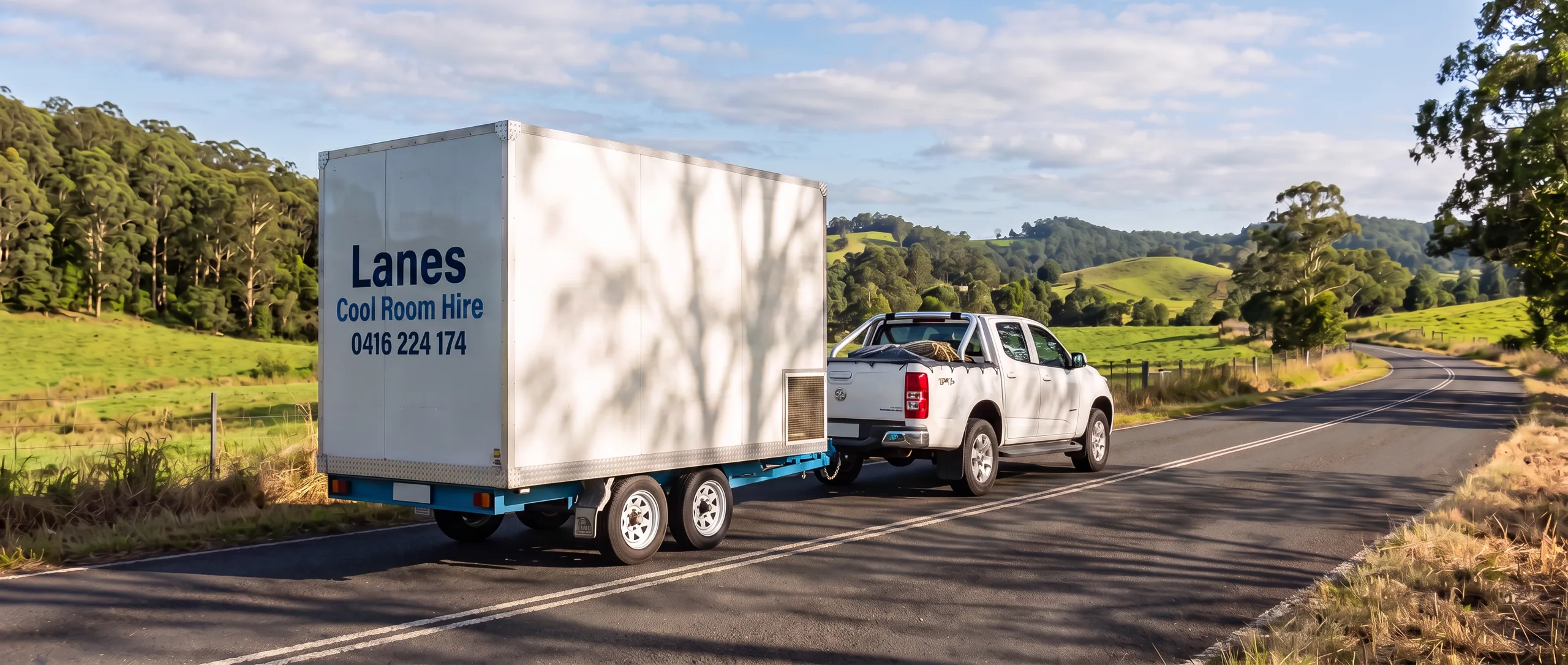 Ute towing a Lanes coolroom trailer along a Northern Rivers country road